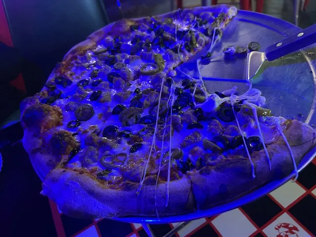 Sausage Jalapeño and Black Olives Under a Blue Light